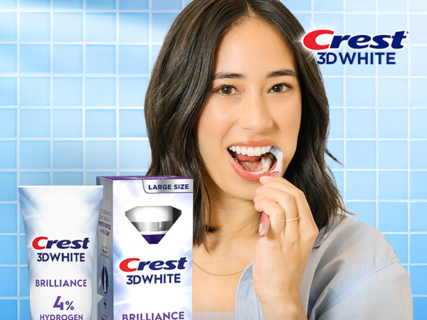 Happy woman brushing her teeth with Crest 3DWhite.