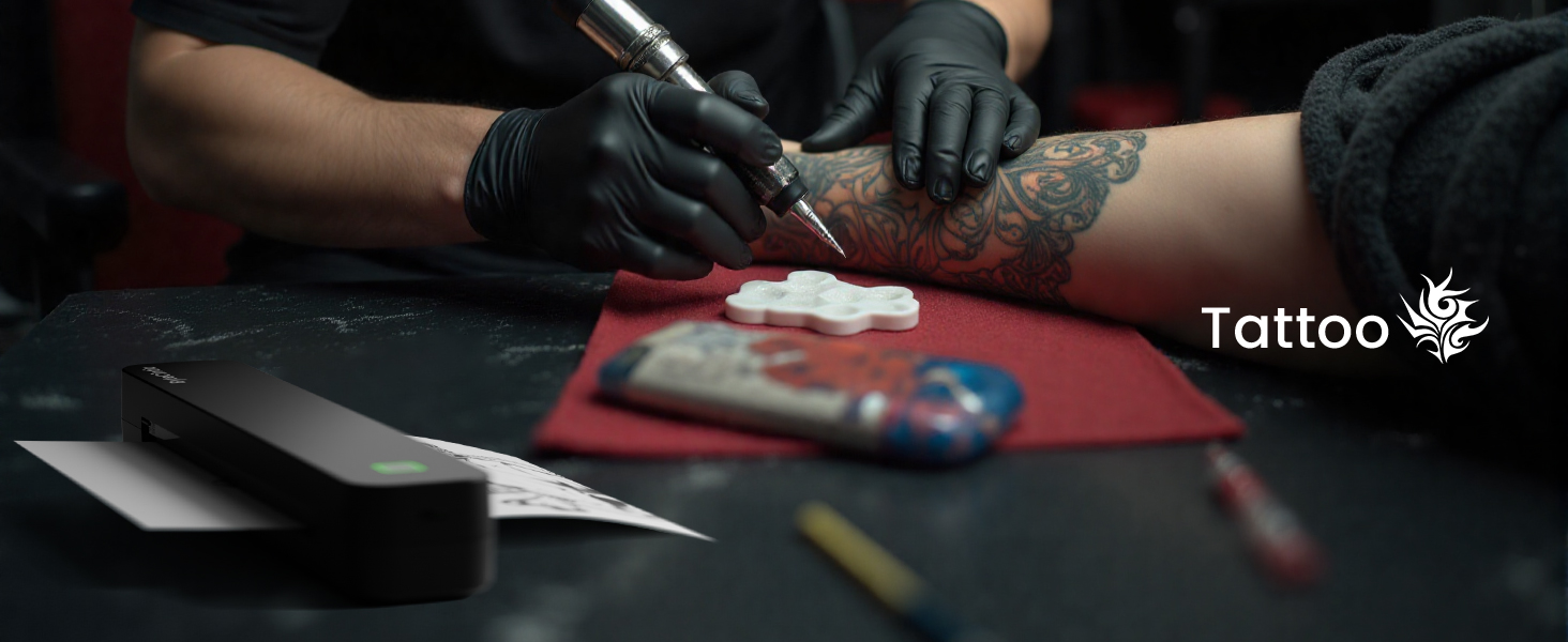 Text reads 'Tattoo'. Close-up view of tattoo application process, showing gloved hands working with tattoo machine on skin.