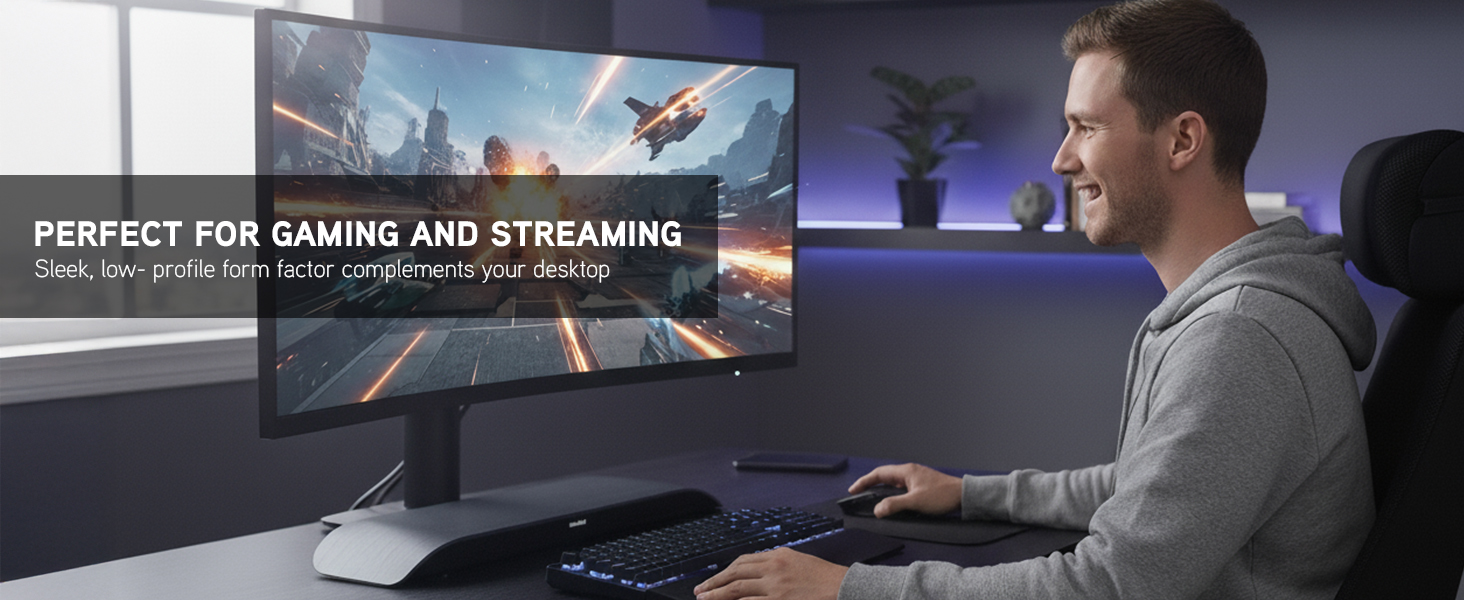 Man gaming at desk with curved monitor and Soundblade beneath screen in modern LED-lit workspace