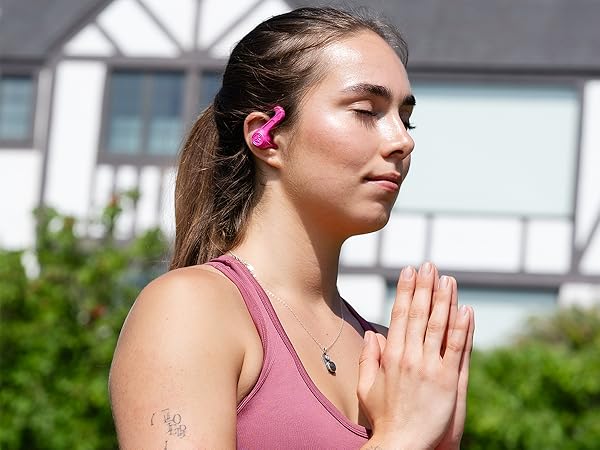 Woman wearing jbuds sport 4 while doing yoga