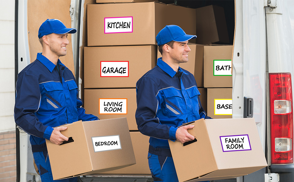 Two movers in blue uniforms carrying labeled cardboard boxes from a moving truck. Boxes indicate various room destinations.