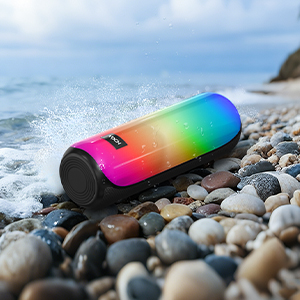 Series of colorful electronic devices with rainbow gradient finish displayed on rocky beach setting. Products show waterproof durability features.