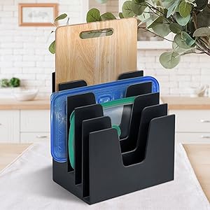 Use your creativity to organize plastic lids, cutting boards and baking sheets over the counter .