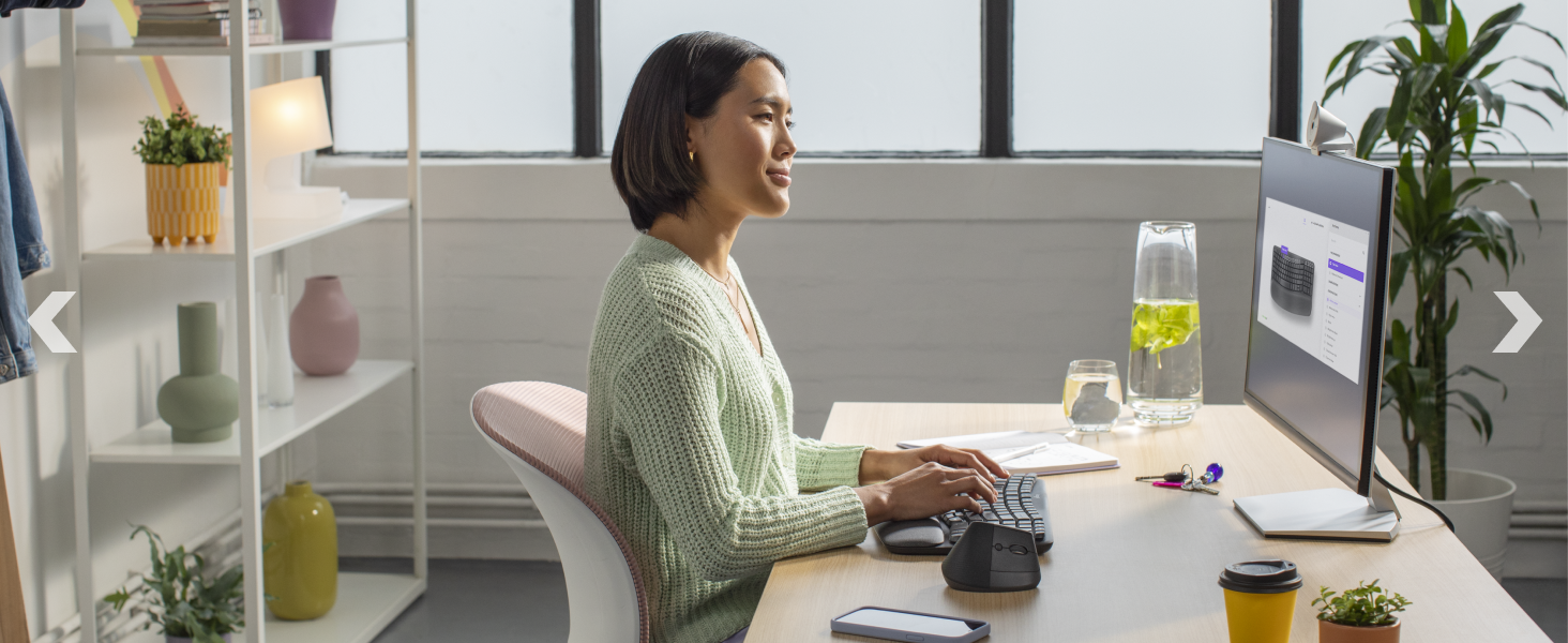 a woman typing on wave keys wireless ergonomic compact keyboard