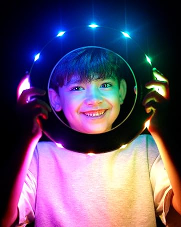 Boy holding a TOSY Flying Ring RGB glowing in the dark