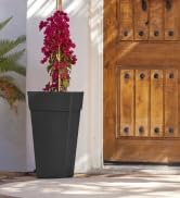 bloem finley tall vertical square planter in black color flanking a home entryway