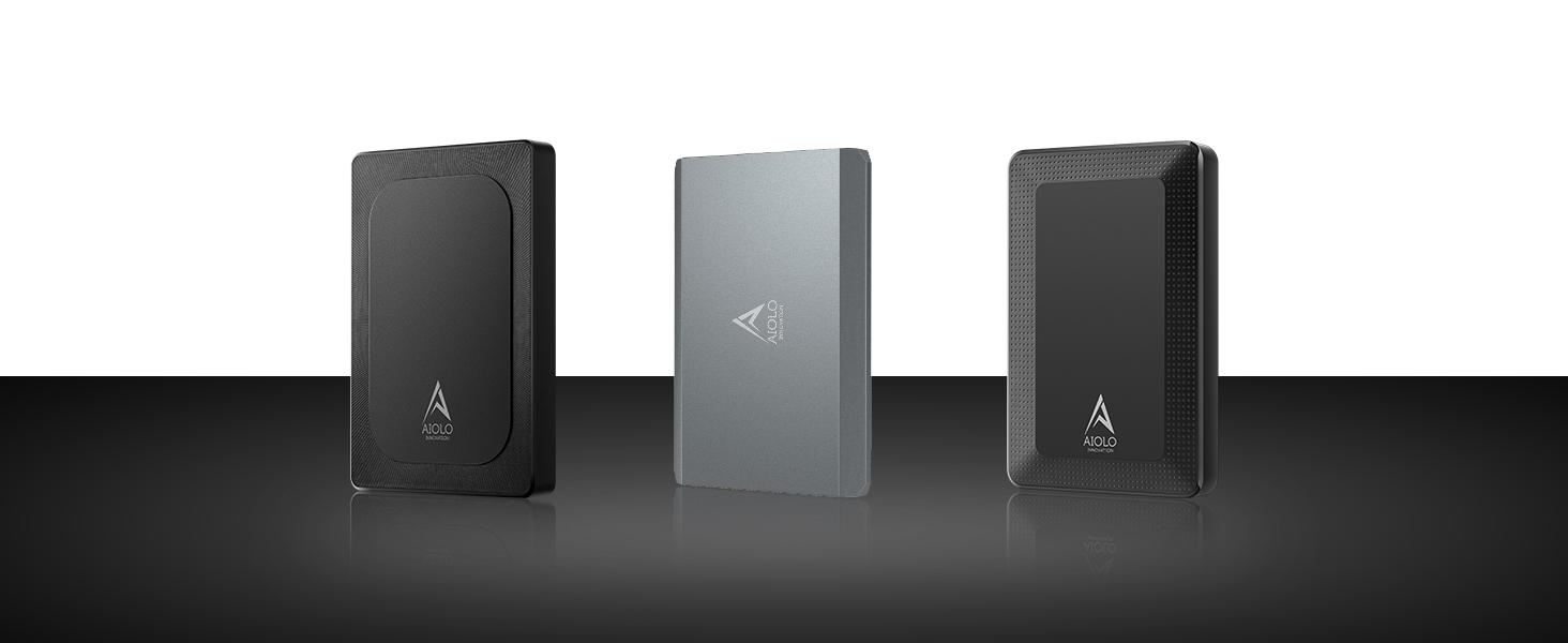 Three rectangular external hard drives or SSDs in black and silver colors, arranged side by side on a reflective surface.