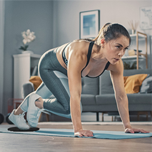 Woman using black Limm Core Sliders for mountain climbers exercise