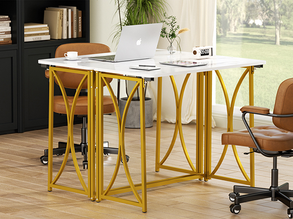 Two folding tables with chairs in a living room, beside a black bookshelf
