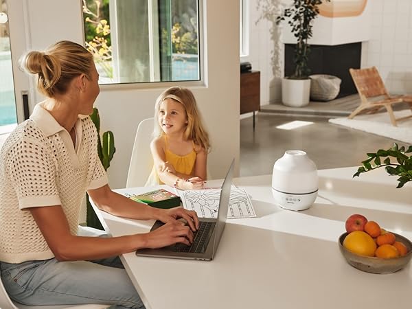 woman and child sitting at kitchen table