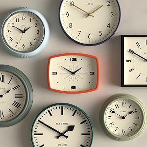 Collection of wall clocks with various designs, shapes, and colors. Includes round, square, and rectangular faces with different numeral styles and frame colors.