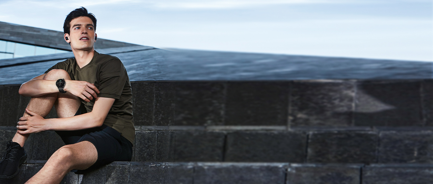 a man sitting on a stone wall
