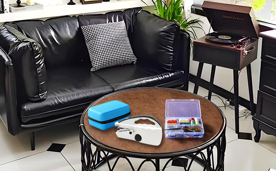 A handheld sewing machine is placed on the living room sofa