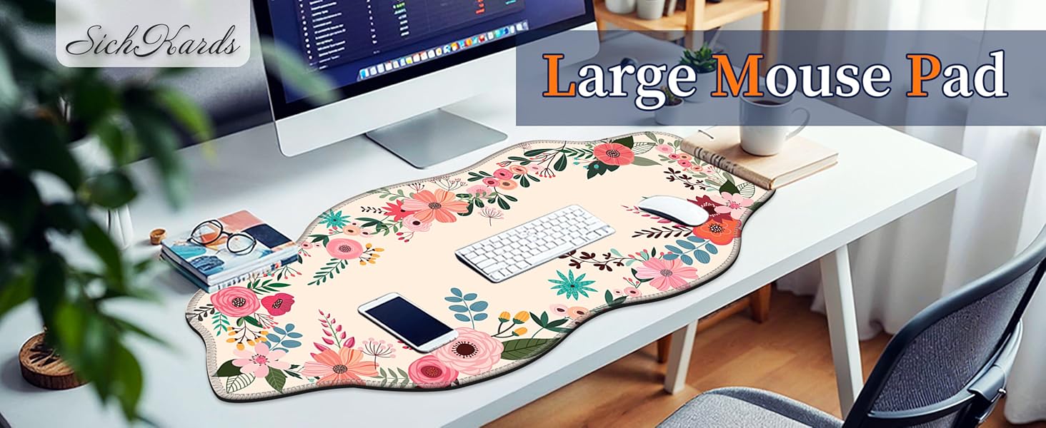 Large floral mouse pad on a white desk with keyboard and phone, creating a cozy workspace decor.