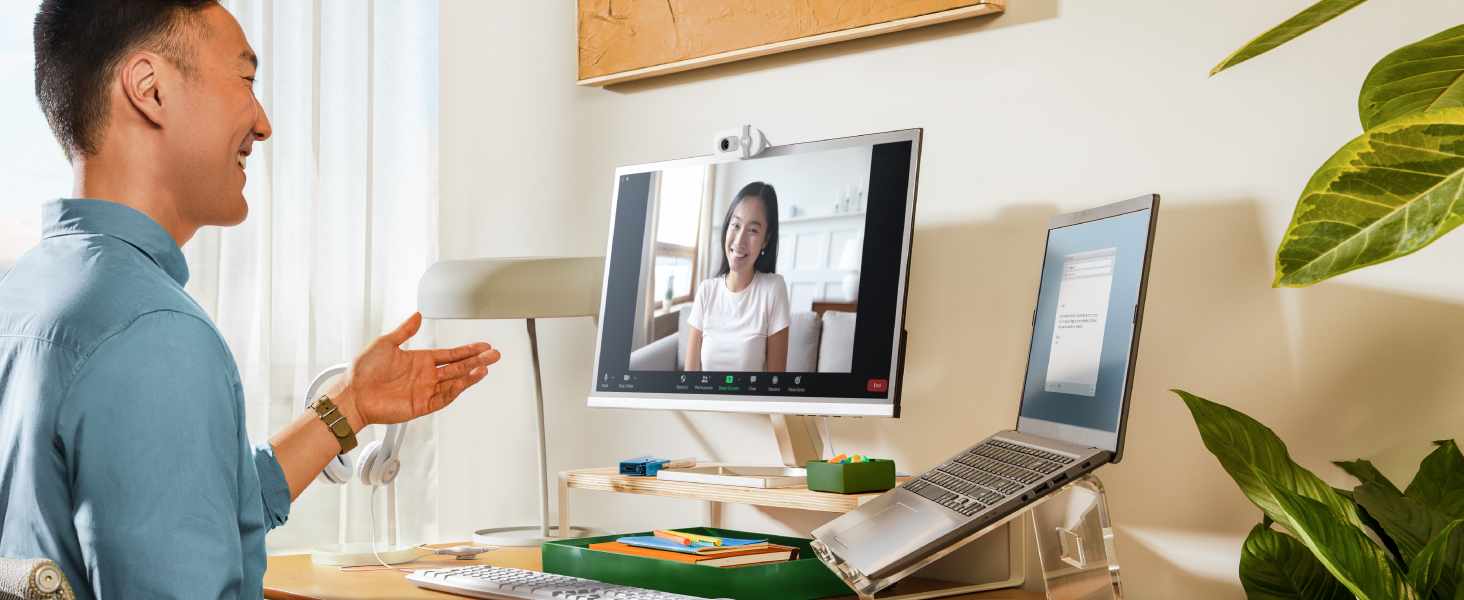 a man having a video call using brio 100 full hd webcam for meetings and streaming