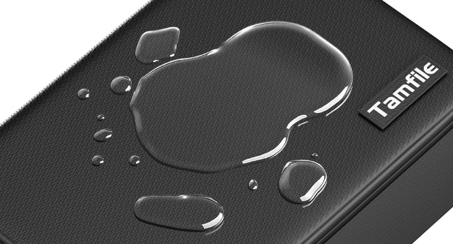 Text reads 'TechStyle'. Close-up of a black textured surface with water droplets beading on it, demonstrating water-resistant or waterproof properties.