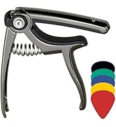 Guitar capo with spring-loaded clamp mechanism, metallic gray finish. Includes set of colorful guitar picks in black, green, blue, yellow, and red.