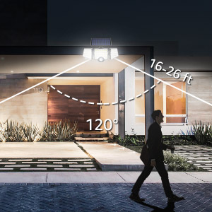 a man walking in front of a house at night.