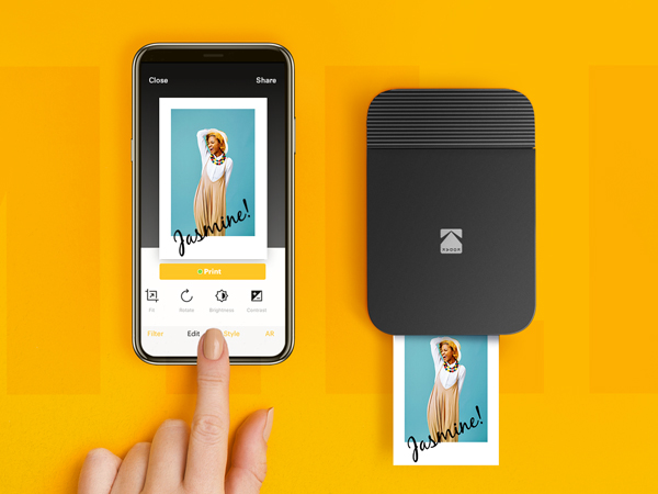 black kodak smile printer with smartphone