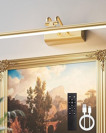 An elegant gallery wall with framed artwork illuminated by soft, warm lighting. The product casts a 