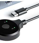 Black circular charging dock or adapter with LED indicator, connected to a USB cable.