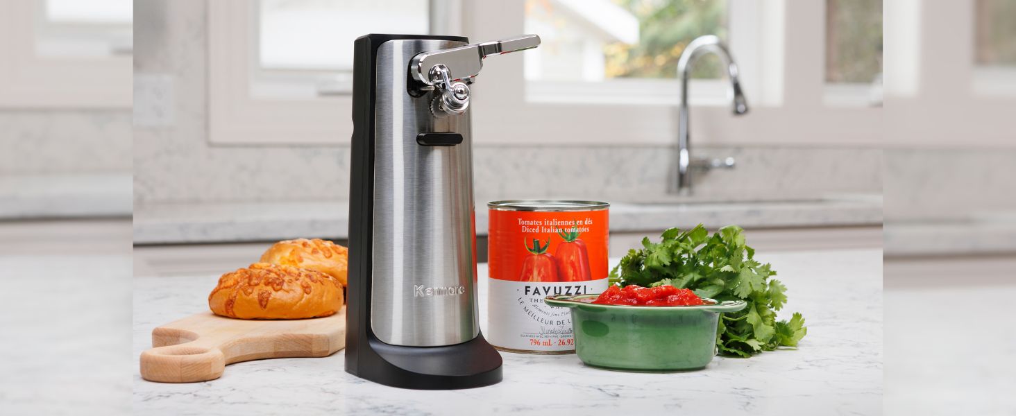 Kenmore 3-in-1 automatic electric can opener surrounded by food on a white marble countertop