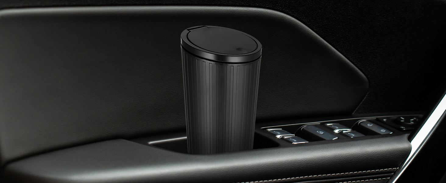 Black cylindrical cup holder or storage container mounted in what appears to be a vehicle's interior panel or armrest.