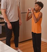 Microlife Peak Flow Meter in use by a child with an adult supervising