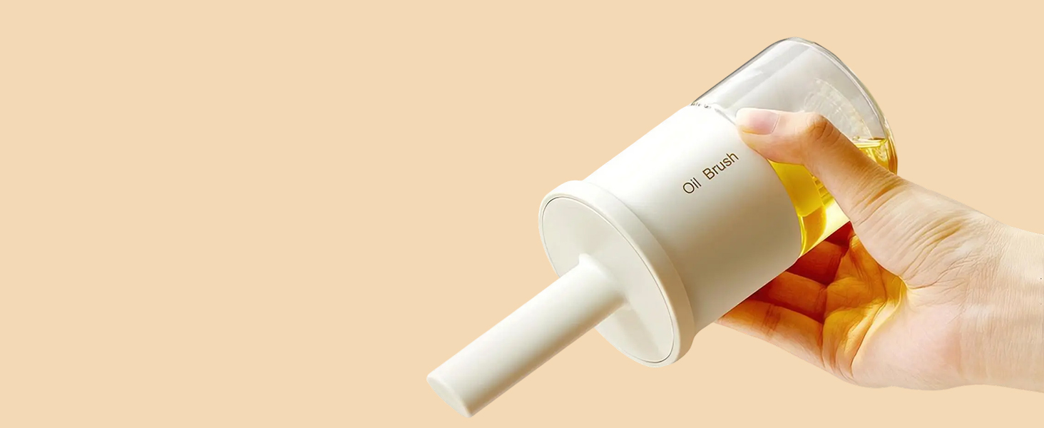 Hand holding a white plastic oil pump dispenser with a clear container filled with yellow liquid, likely cooking oil.