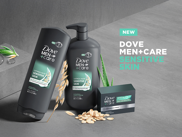 Dove Men+Care Sensitive Skin products with oats, aloe leaves and droplets on a gray backdrop.