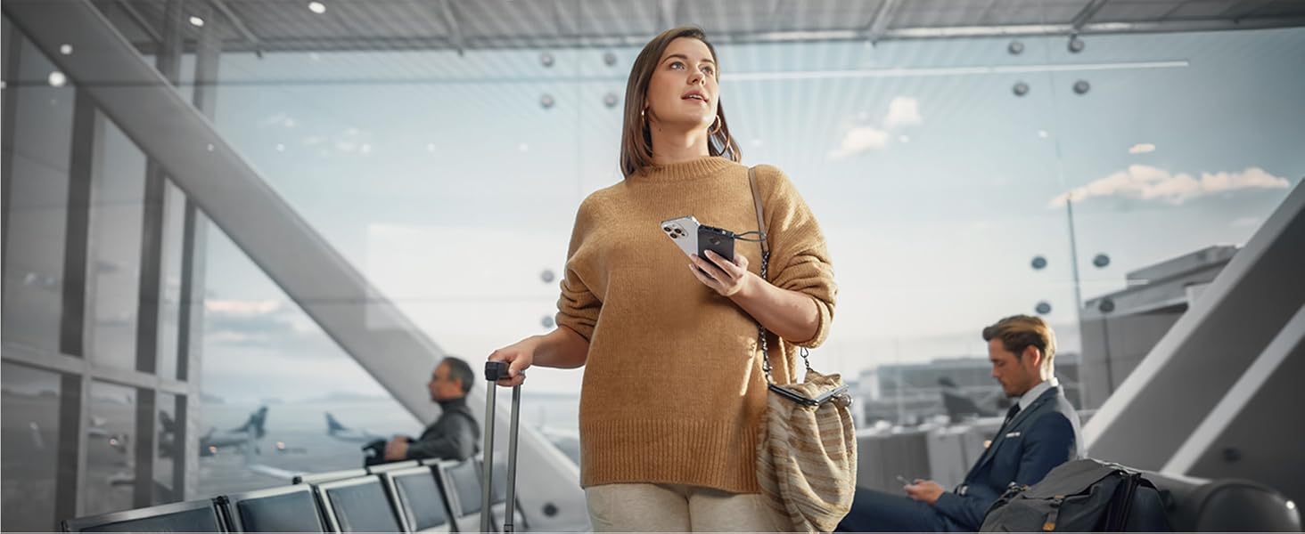 a woman holding a cell phone in a airport