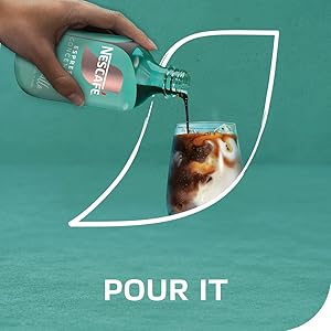 A bottle of NESCAFÈ Espresso Concentrate being poured into a glass of milk and ice. Tagline: Pour it