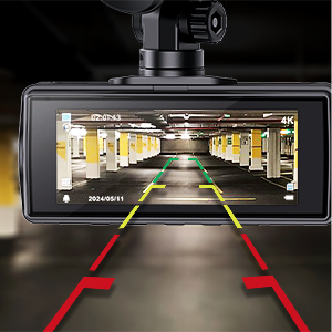 Dashboard camera display showing parking guidance with yellow guidelines and red warning lines in an indoor parking structure.