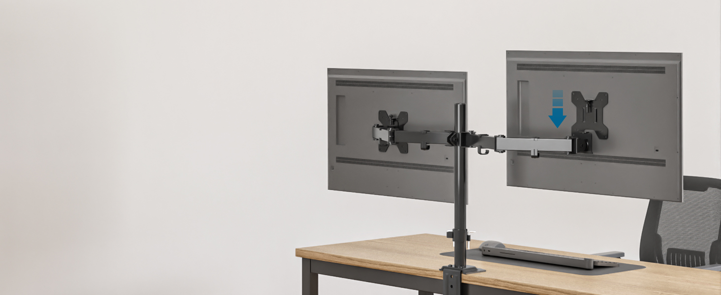 Dual monitor arm mount attached to a desk, supporting two computer screens. The mount features adjustable arms for flexible positioning of displays.