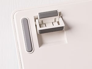 White rectangular device component showing a small protruding mount and elongated slot, possibly for electronic device assembly or mounting.