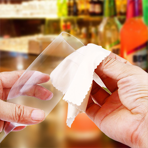a person cleaning a glass with a cloth