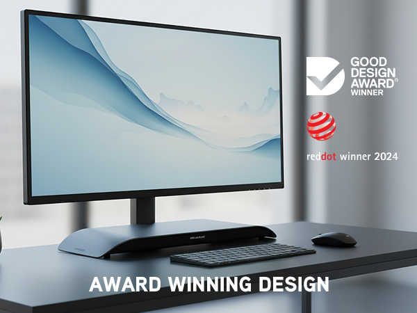 Charcoal SoundBlade under monitor on minimalist desk with award logos and premium design