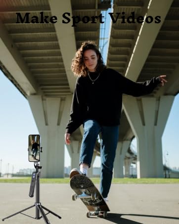 Mobile phone mounted on tripod for video recording, positioned near skateboarding scene under bridge or overpass structure.