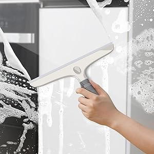 a hand holding a window cleaner with a white background