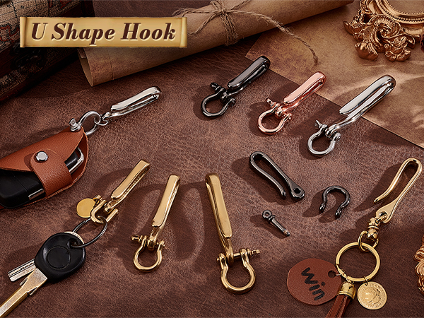 Assortment of U-shaped metal hooks and keychains in various colors and sizes displayed on brown leather surface. Text reads 'U Shape Hook'.