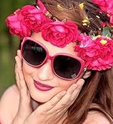 Pink sunglasses with floral decorative frame, shown with bright pink floral crown in outdoor setting.
