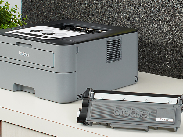 TN660 Toner Cartridge Next to Printer